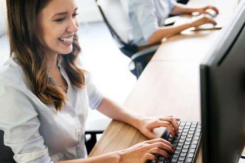 women typing on a computer